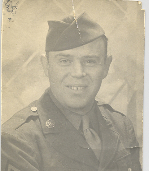 Wilbur Howard Carroll smiling in a military uniform and cap.