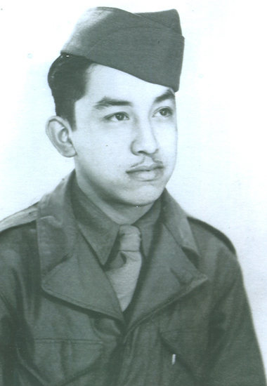 Young serviceman wearing a military uniform and garrison cap.