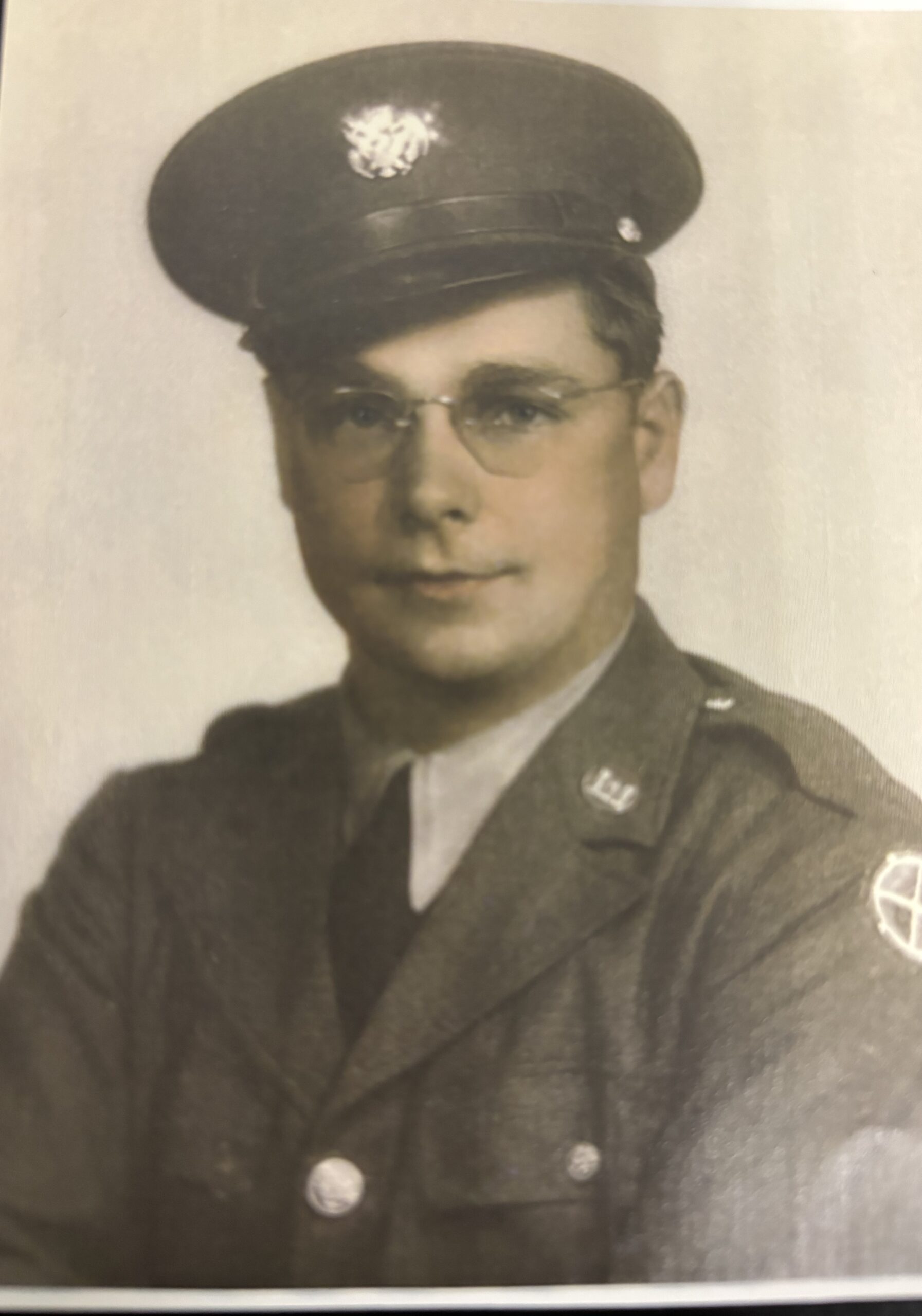 A man in military uniform is shown in a black-and-white photo.
