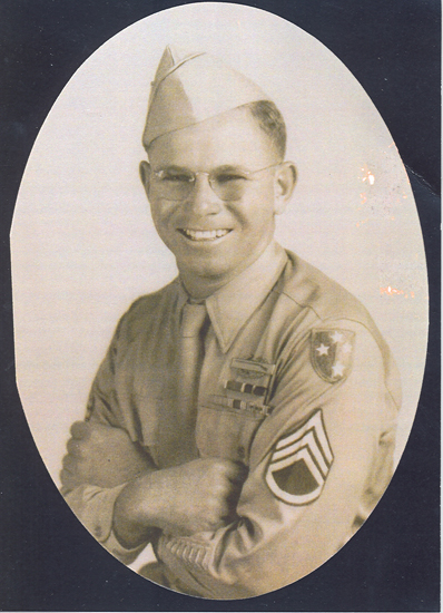 Smiling serviceman wearing a U.S. Army uniform in a formal portrait.
