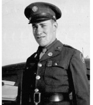 A man wearing a military uniform. The image is from the waist up, and he is smiling at the camera. The uniform includes a cap, jacket, and tie, with medals on his chest. He appears to be looking directly at the camera.