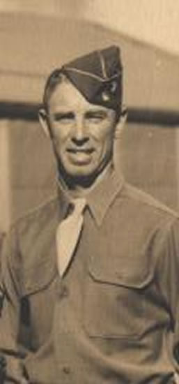 An man in military uniform, looking at the camera.