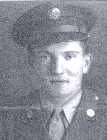 Young serviceman wearing a military uniform and peaked cap.