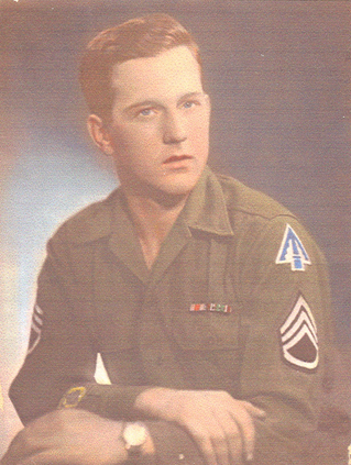 Serviceman wearing a military uniform with rank insignia and service ribbons.