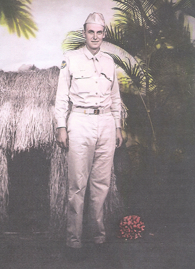 A man in military uniform stands before a tropical backdrop, poised with confidence and professionalism.