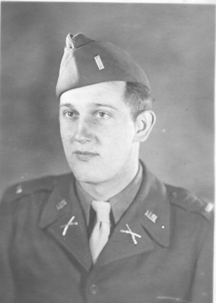 Young serviceman wearing a military uniform and garrison cap.