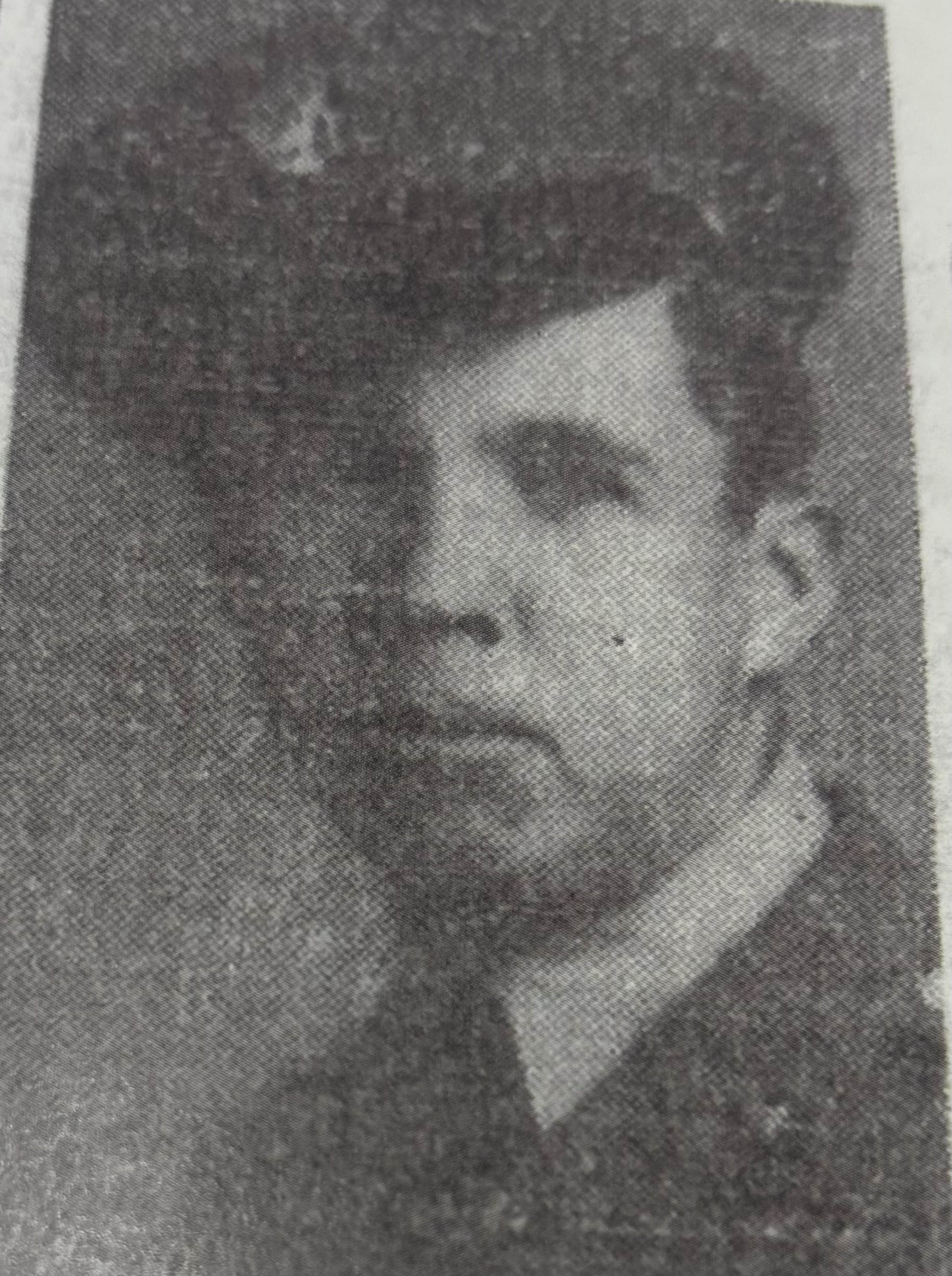 A black and white newspaper photo of a man in uniform. He appears to be posing for the photograph with a serious expression. The man is wearing a military uniform.