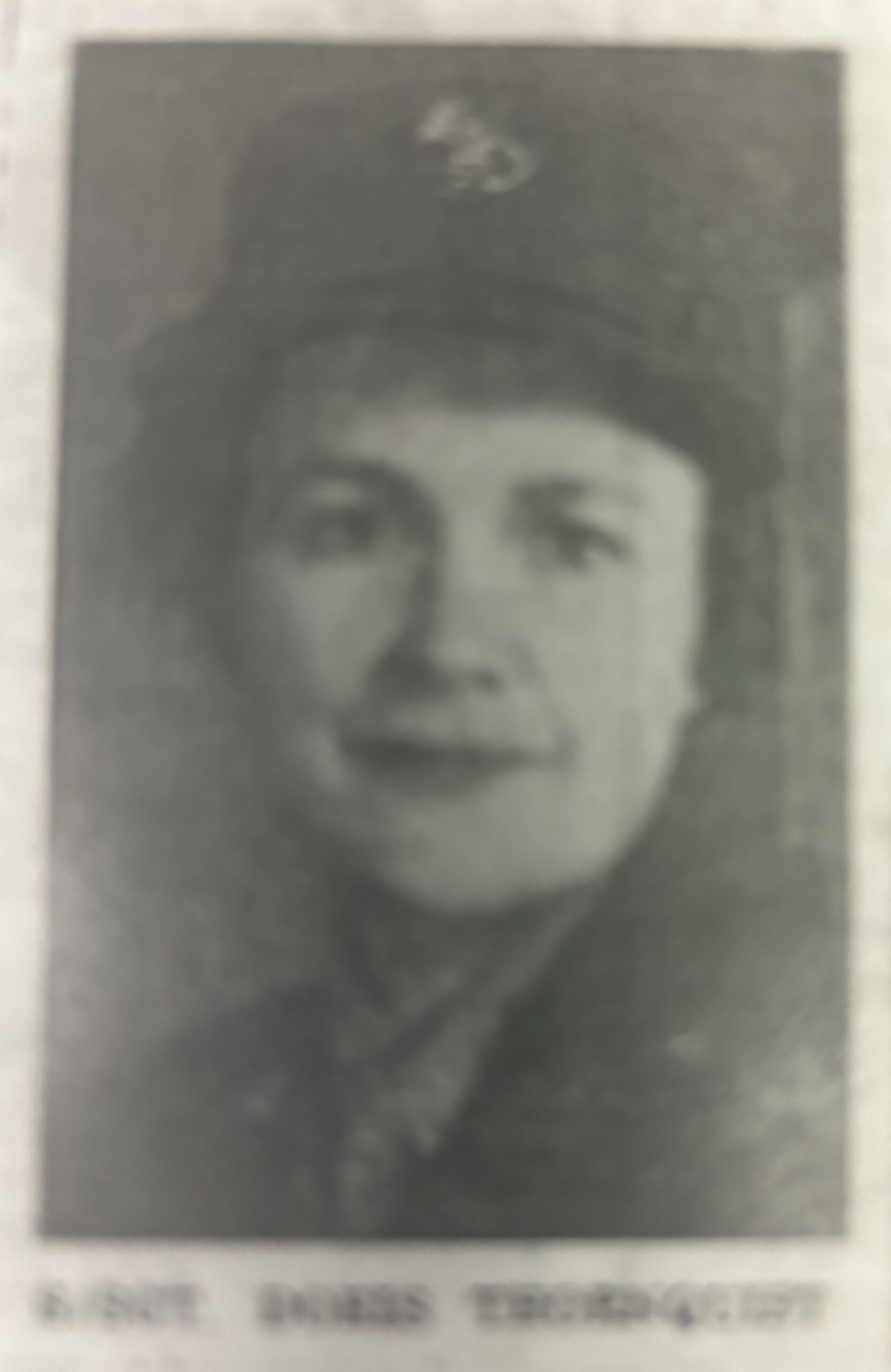 A woman in a formal uniform smiling for her photograph.
