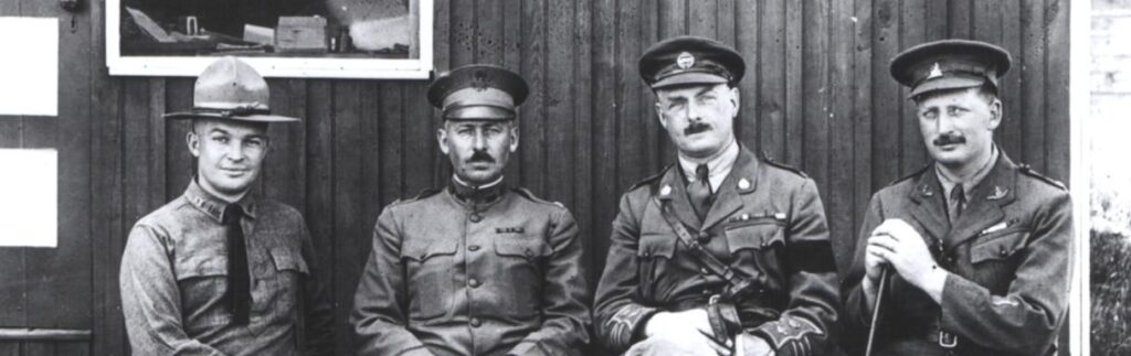 Dwight D. Eisenhower stands beside British tank officers at Camp Colt during World War I.