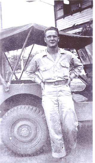 Dale Edward Fisher standing outdoors in a light-colored military uniform.