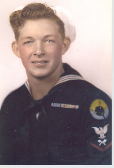 The image features an old photograph of a person wearing a U.S. Navy sailor uniform.