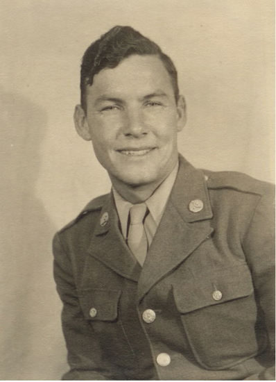 A man in military uniform smiling at the camera for a sepia-toned portrait.