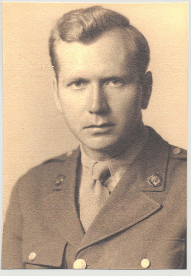 A sepia-toned photograph of a military man in uniform posing for portrait. He looks at the camera with a stern expression.