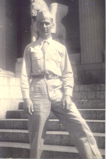 Earl John Klein standing outside a building in a military uniform.