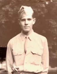 Young Edward Goodnow standing outdoors in a light-colored shirt.