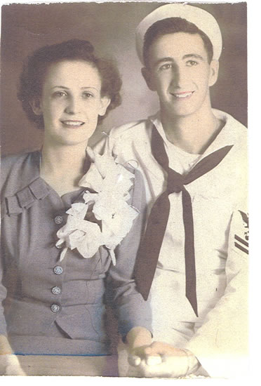 Sailor posing with a woman in a formal portrait.