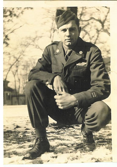 Elmer Alvin Richards seated outdoors in a military uniform.