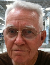 Older Elmo Barton wearing glasses in a close-up color portrait.