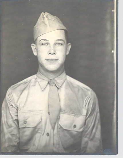 Elvin George Haslouer wearing a military uniform and garrison cap.