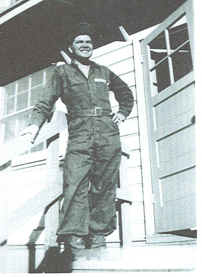 Eugene Ogden Helsel standing outside a building in military flight gear.
