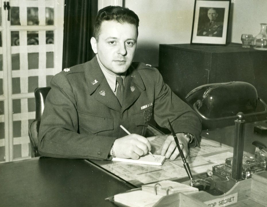 Erwin H. Ezzes seated indoors in a U.S. Army uniform.