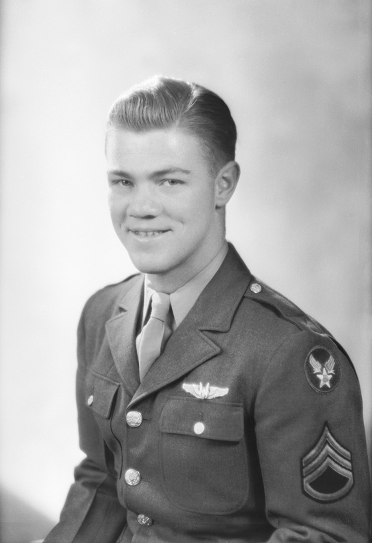 Smiling young serviceman wearing a military uniform.