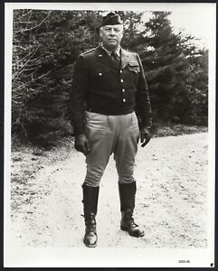 George Kennedy standing outdoors in a military uniform.