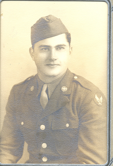 Serviceman wearing a military uniform and garrison cap.