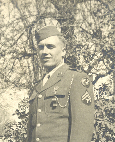 Glen Earl Flinn standing outdoors in a military uniform and garrison cap.