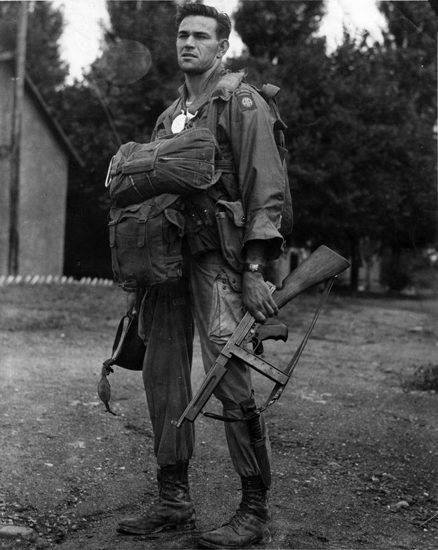 Soldier outdoors in a field uniform with military equipment.