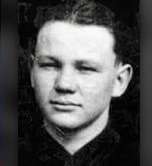 Young serviceman shown in a close-up black-and-white portrait.