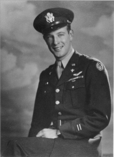 Smiling military officer wearing a decorated uniform.