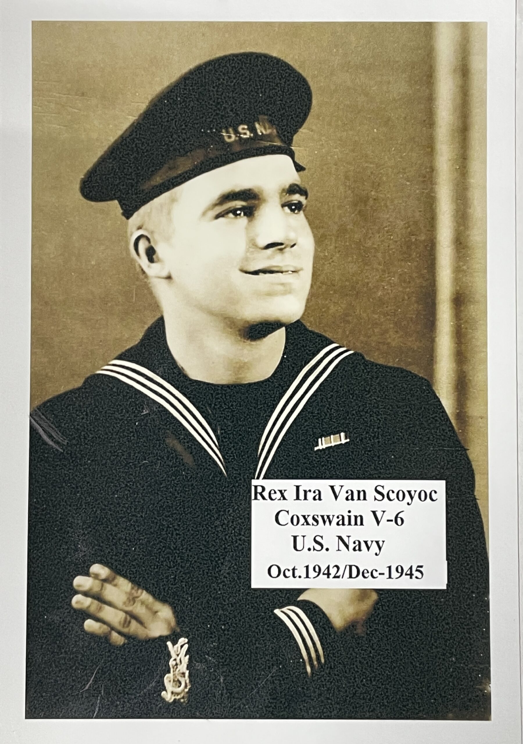 Sailor wearing a U.S. Navy uniform in a formal portrait with text that reads "Rex Ira Van Scoyoc Coxswain V-6 U.S. Navy Oct. 1942/Dec-1945"