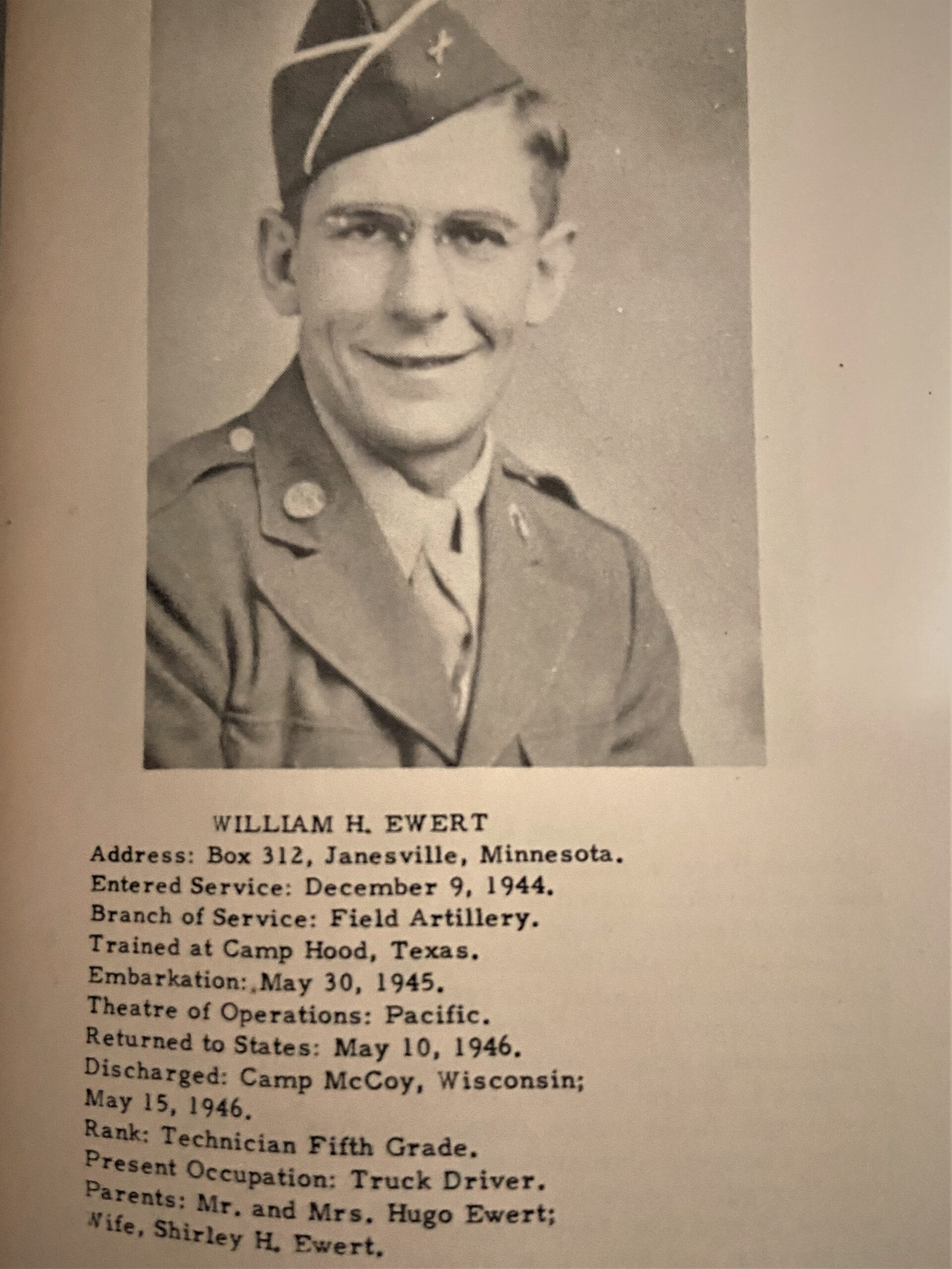 Smiling serviceman wearing a U.S. Army uniform in a formal portrait.