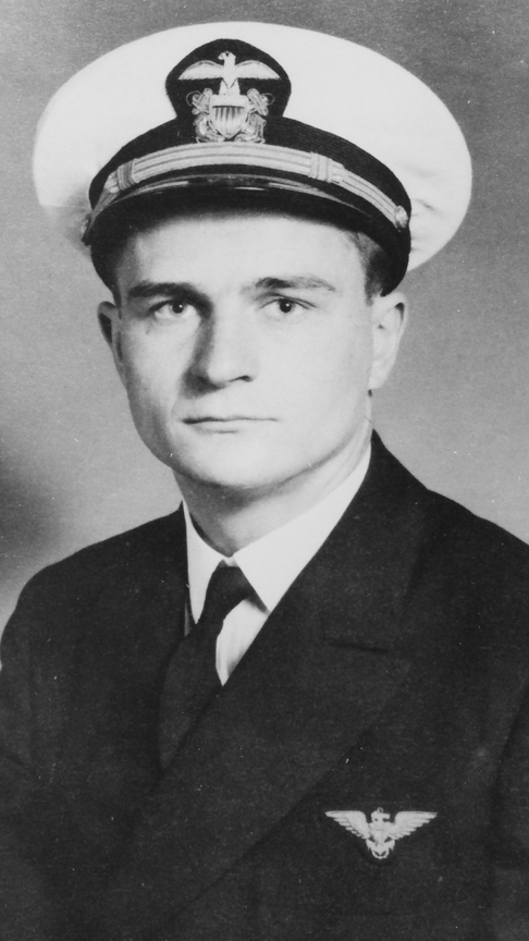 Young man wearing a dark formal uniform in a black-and-white portrait.