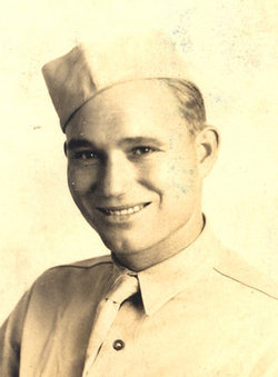 Smiling James Marcell Gaddy wearing a military garrison cap.
