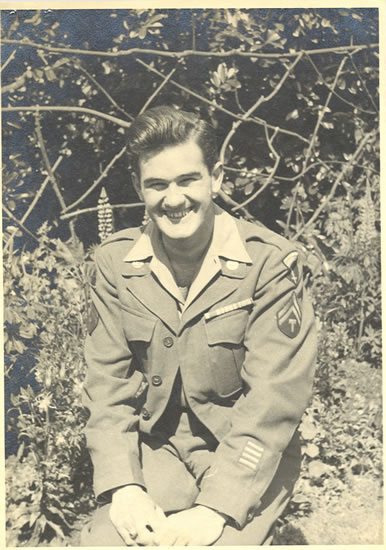 Smiling John Joseph Peters wearing a military field uniform outdoors.