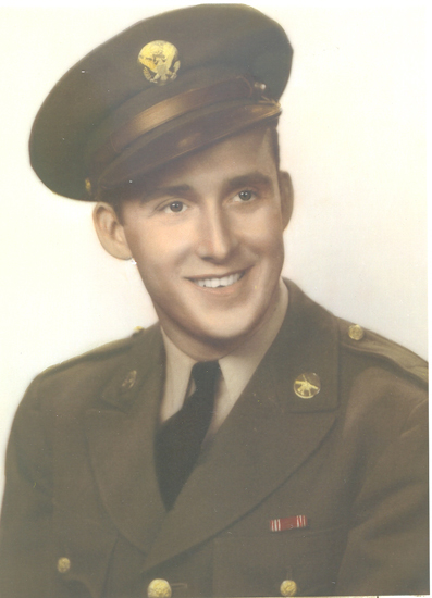 Smiling Elmer Keech wearing a military uniform and peaked cap.