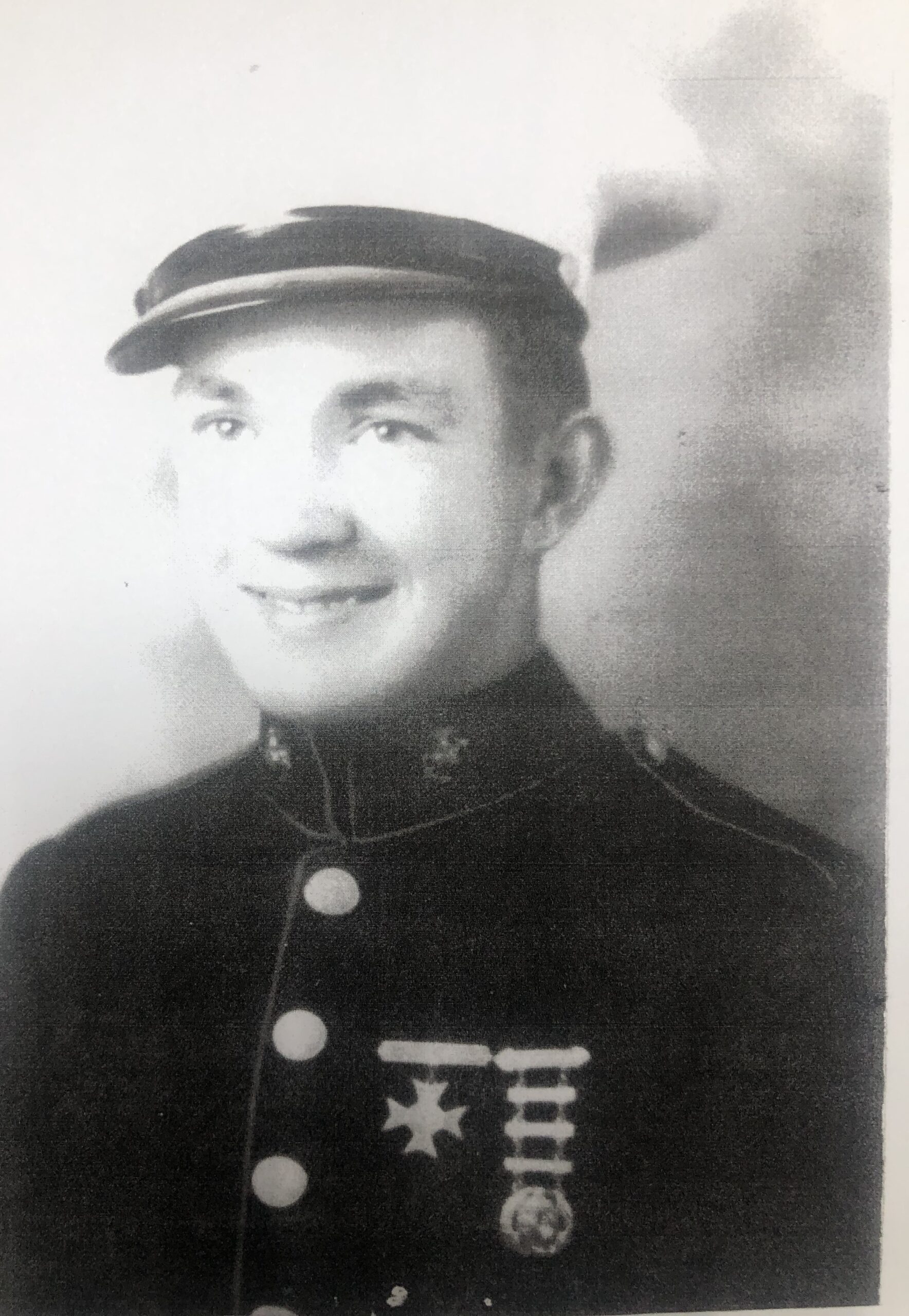 Smiling Keith Beadleston wearing a military uniform and peaked cap.