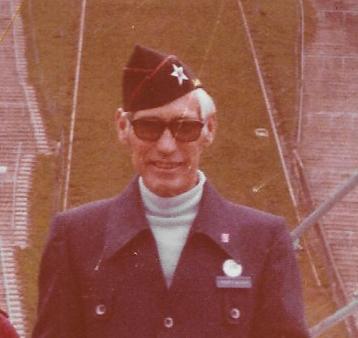 Older veteran wearing sunglasses and a military garrison cap.