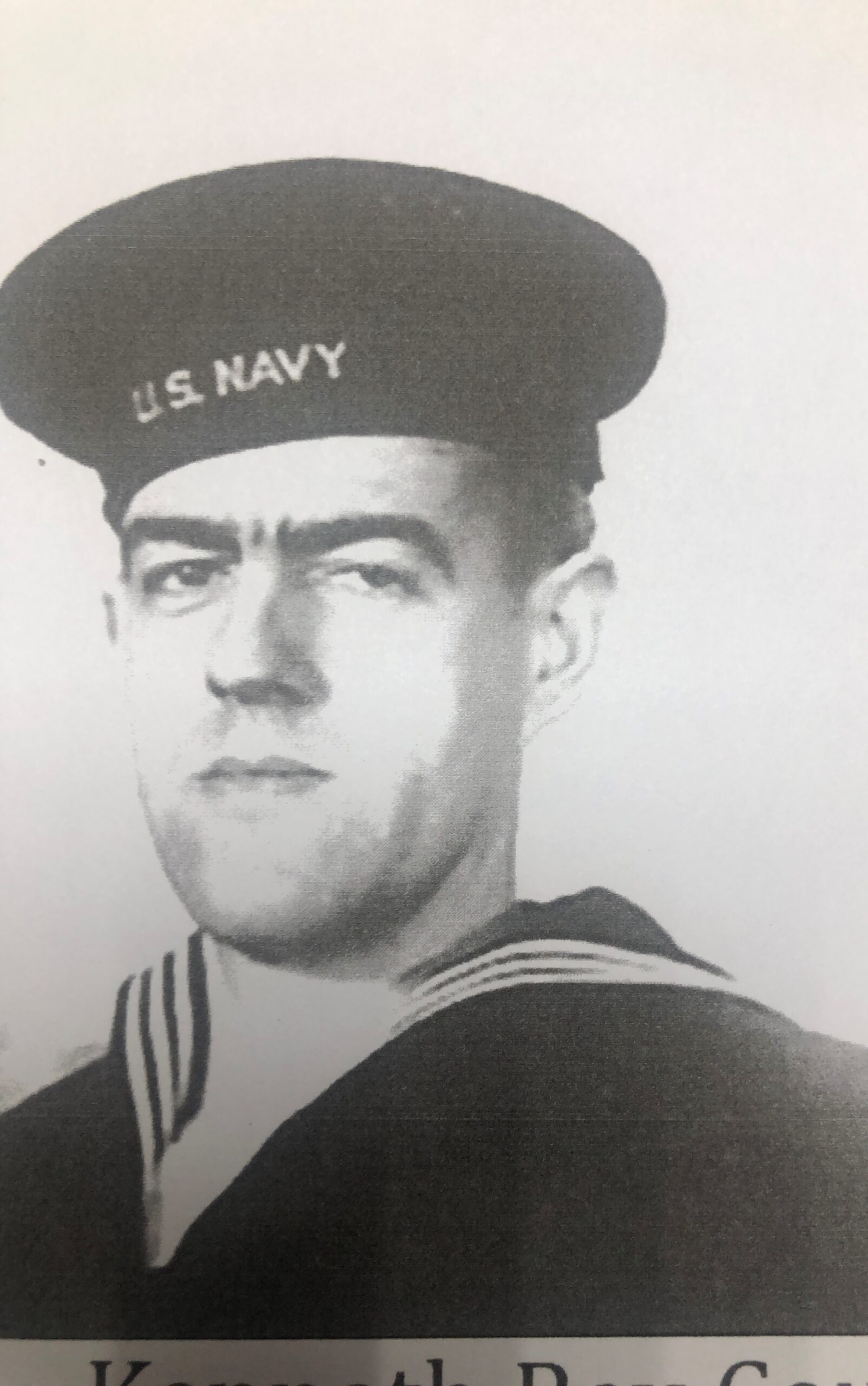 Kenneth Coop wearing a U.S. Navy uniform and cap.