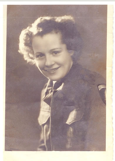 Smiling woman shown in a formal black-and-white portrait.