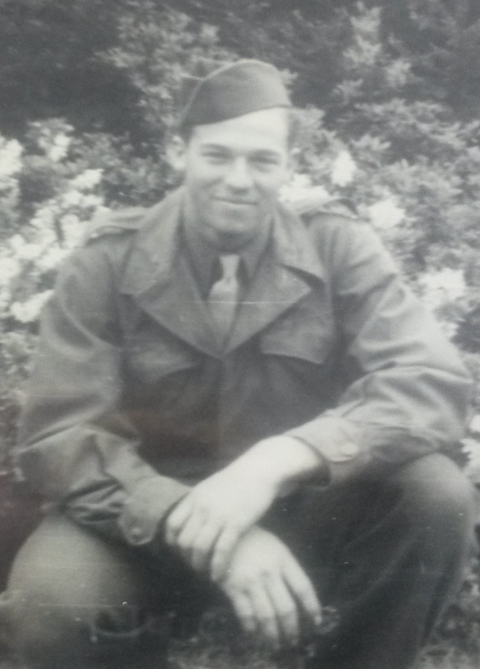 Young serviceman seated outdoors in an Army Air Forces uniform.