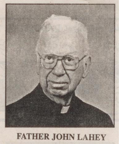 Father John Lahey wearing glasses in a formal portrait.