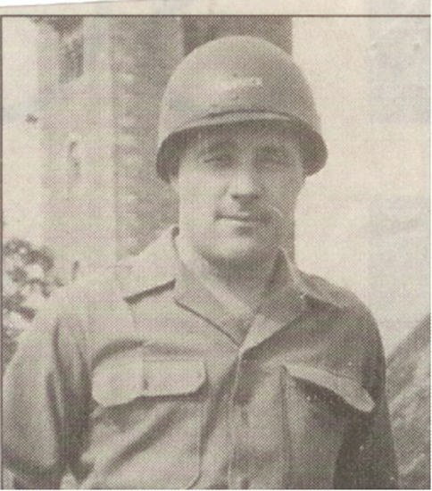 Serviceman wearing a military helmet and field uniform.