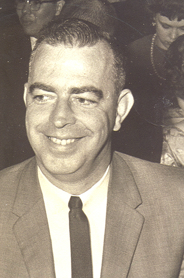 Smiling older man wearing a suit and tie.