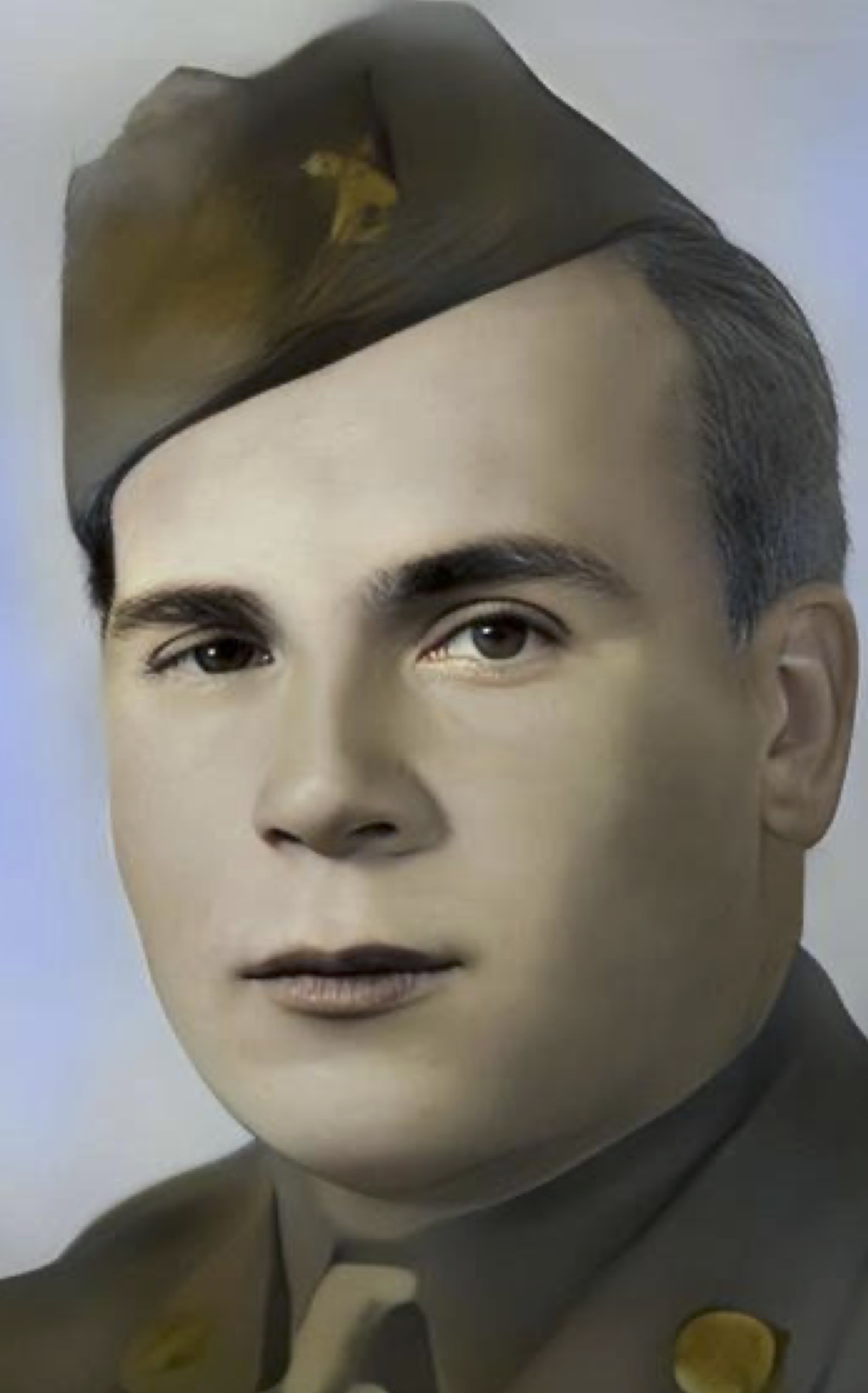 Close-up portrait of Lawrence wearing a military garrison cap.