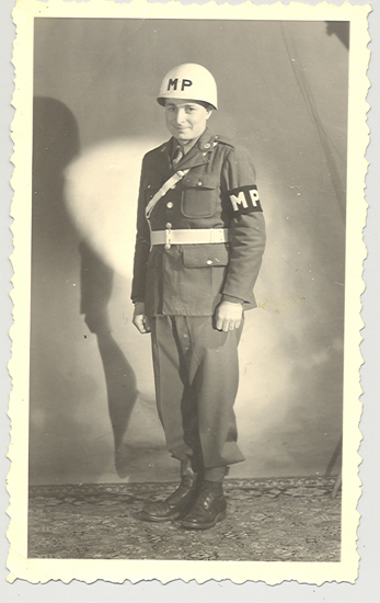 Leo James Hocker standing indoors in a military police uniform.