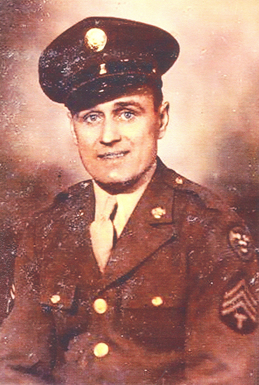 A man in military uniform. He has short hair and is wearing a cap.