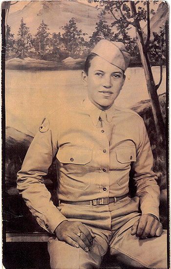 Robert G. Linder seated outdoors in a light-colored military uniform.
